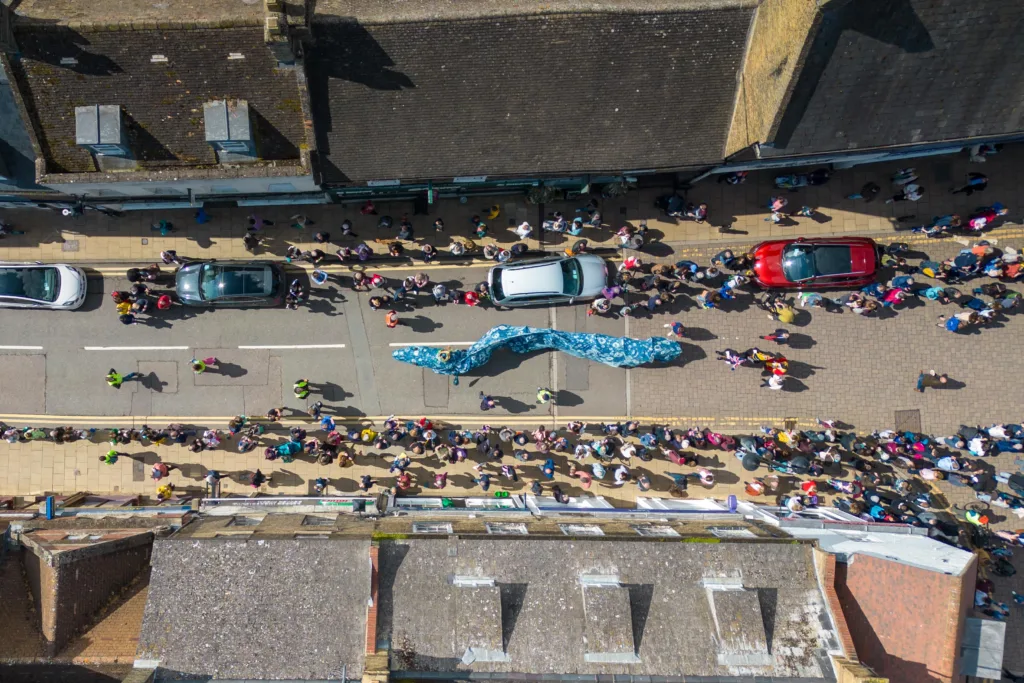 Ely EEL Festival makes its way through the city - News for Peterborough Dubbed ‘Coronation Eel Day’ the spectacular eel focal point snaked its way from Cross Green through the streets to Jubilee Gardens to begin a packed day of events by the river.