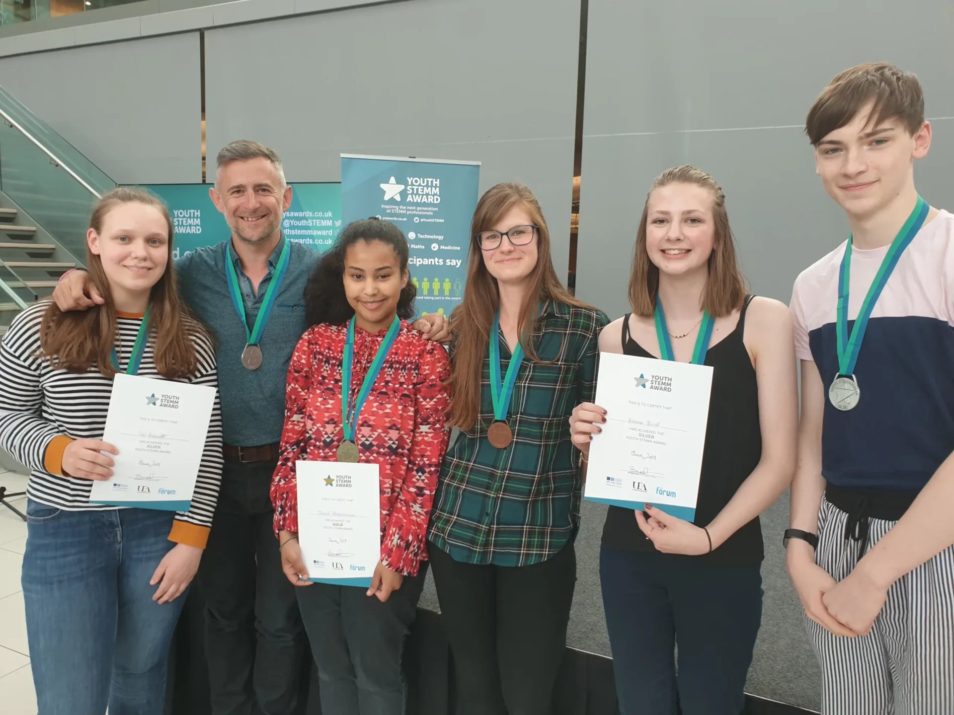 News for Peterborough - Image caption: Young people receiving their Youth STEMM Award medal from YSA ambassador Mark Thompson (BBC Stargazing Live broadcaster and author). Image credit: John Innes Centre.