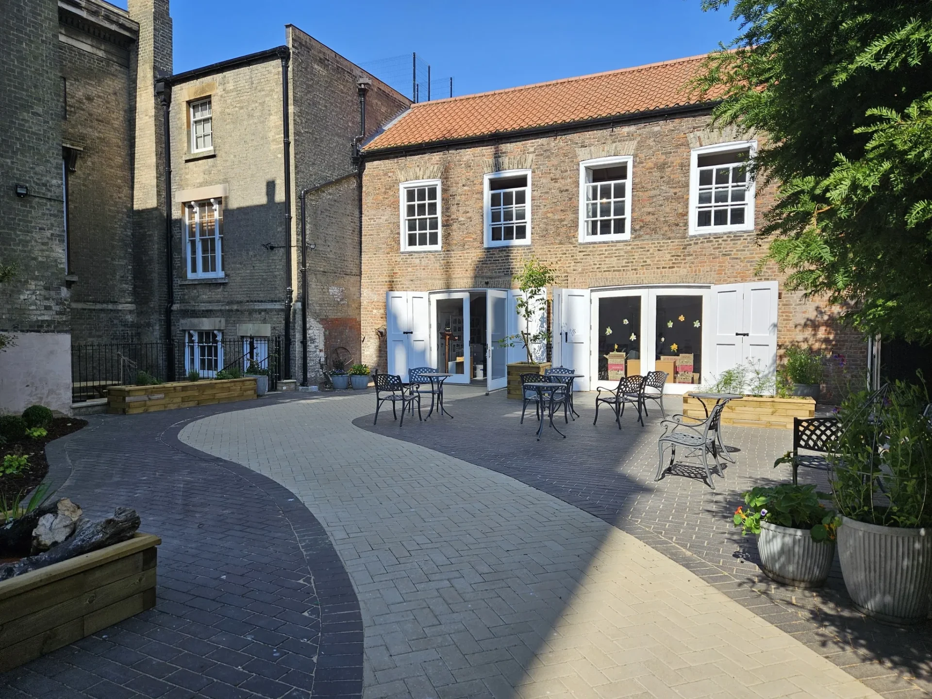 News for Peterborough - All visitors now enter through the new garden opposite St Peter's Church tower on museum open hours, 10 - 4, Wednesday to Saturday.