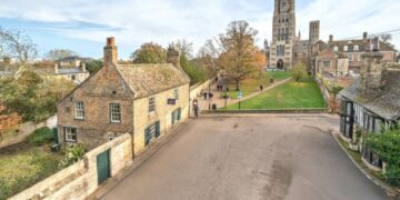 An estate agent has REMOVED a photo from a listing for a Grade II listed house overlooking majestic Ely Cathedral in Cambridgeshire – after admitting it ALTERED the picture to delete the parking bays in front of the cottage. PHOTO: BavMedia